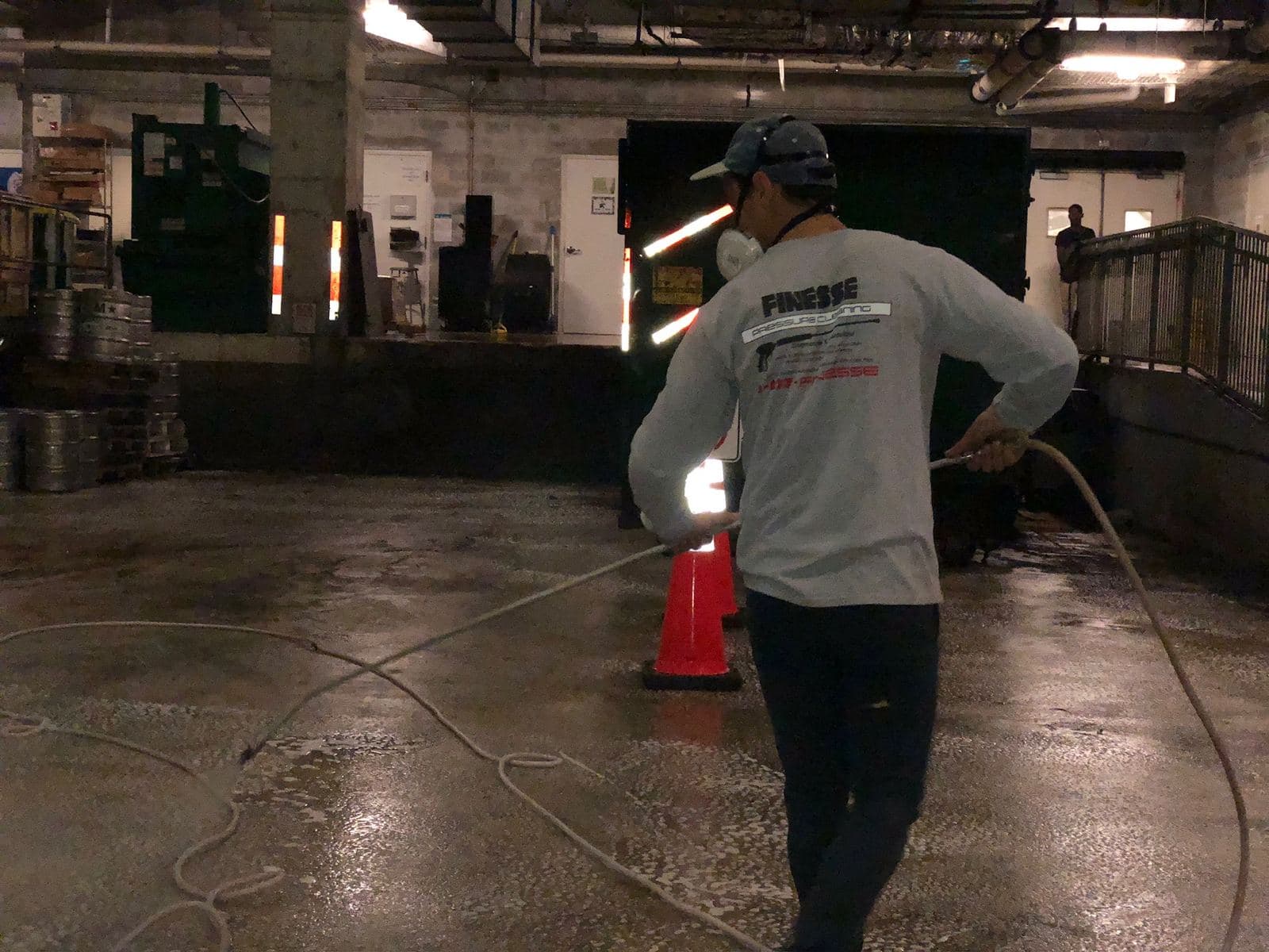 Crew pressure washing a warehouse floor — Finesse Cleaning, South Florida