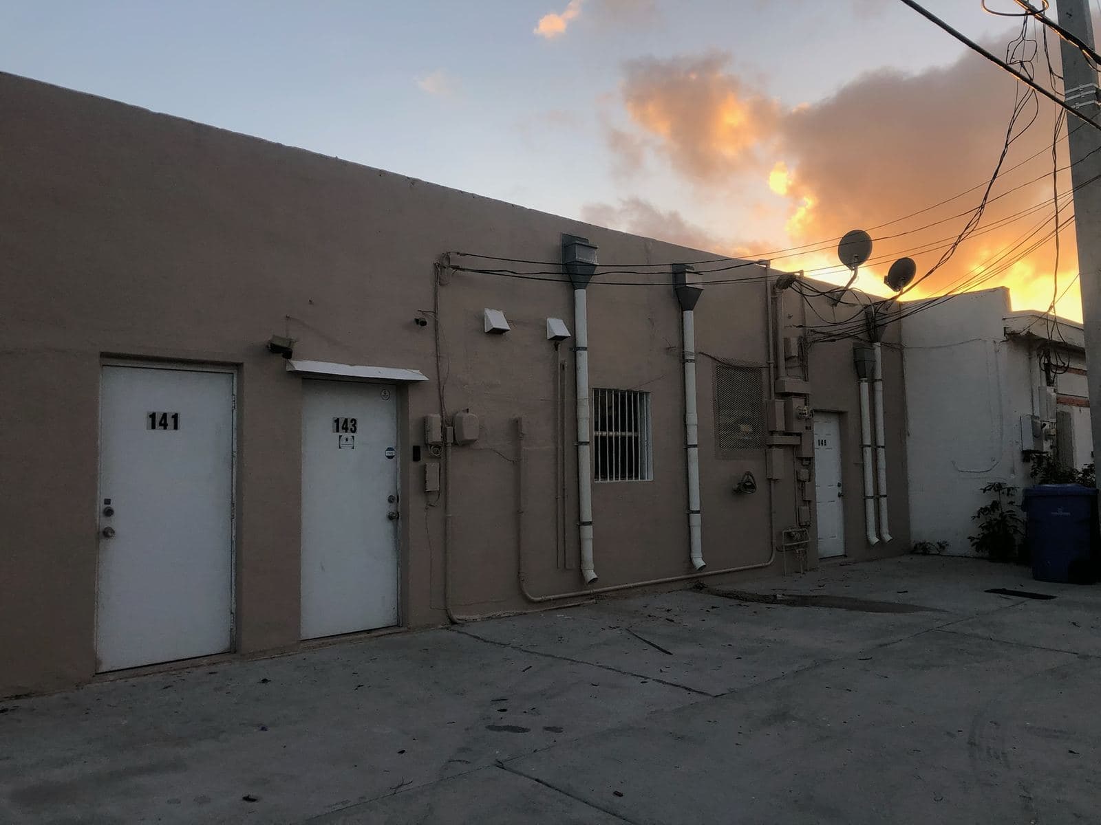 Exterior wall and doors of a commercial building at sunset — Finesse Cleaning, South Florida