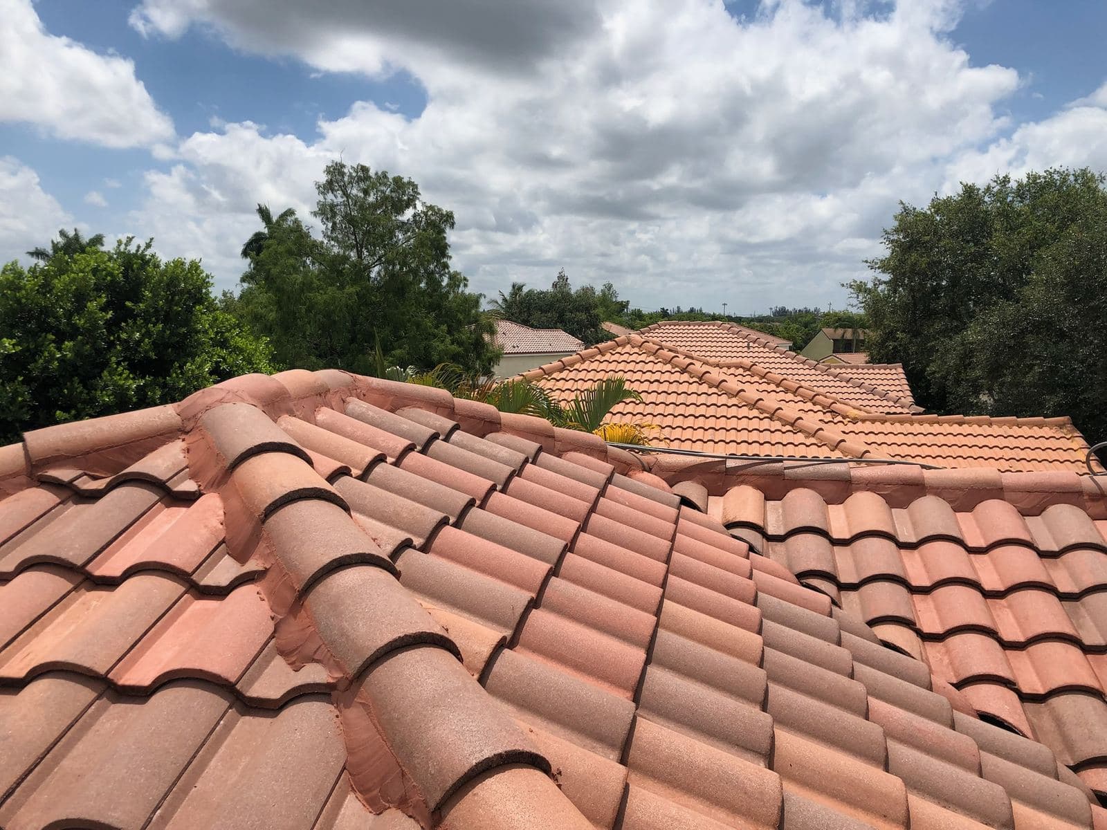 Aerial view of a clean tile roof neighborhood — Finesse Cleaning, South Florida
