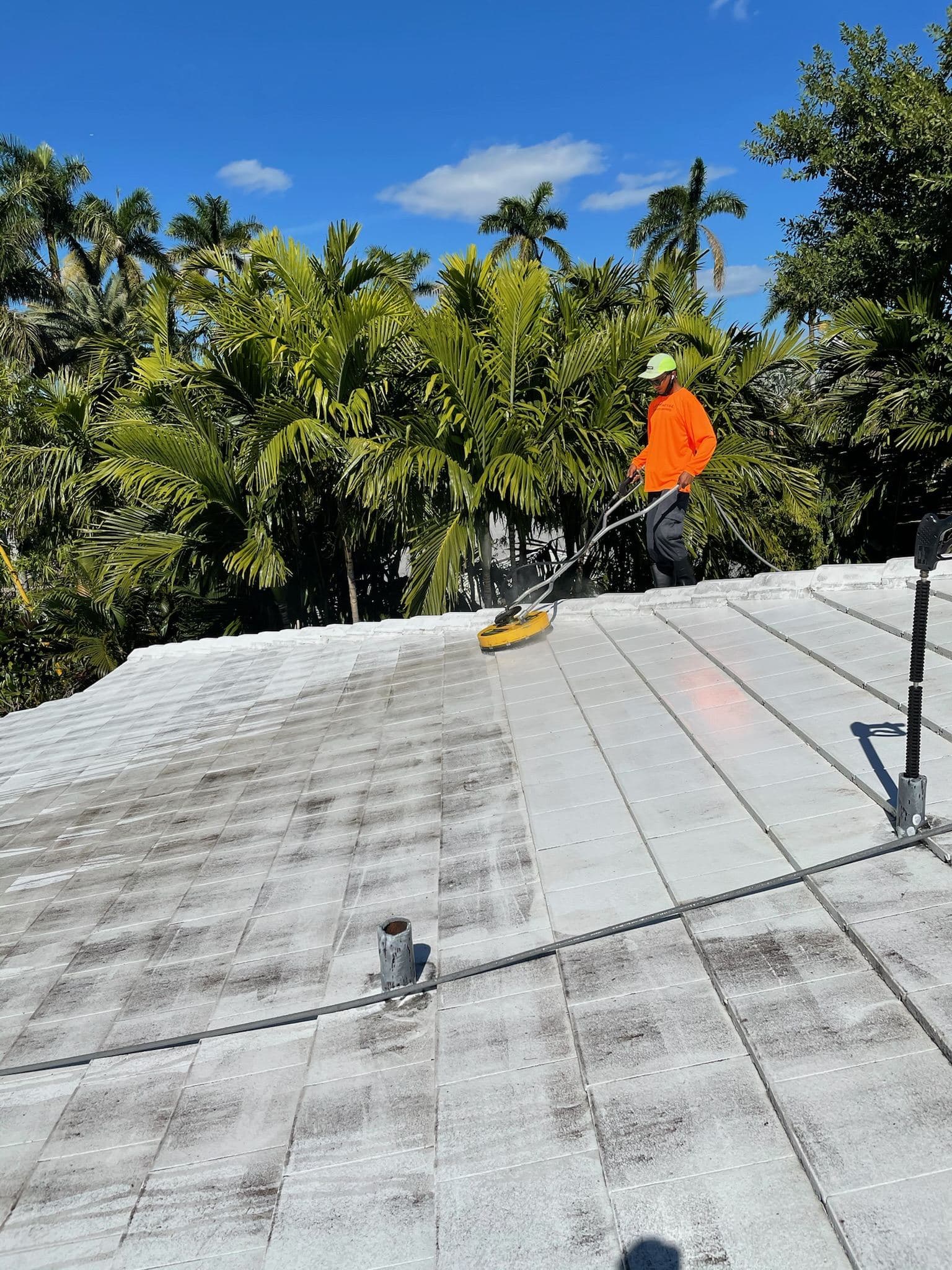 Crew soft washing a flat roof — Finesse Cleaning, South Florida